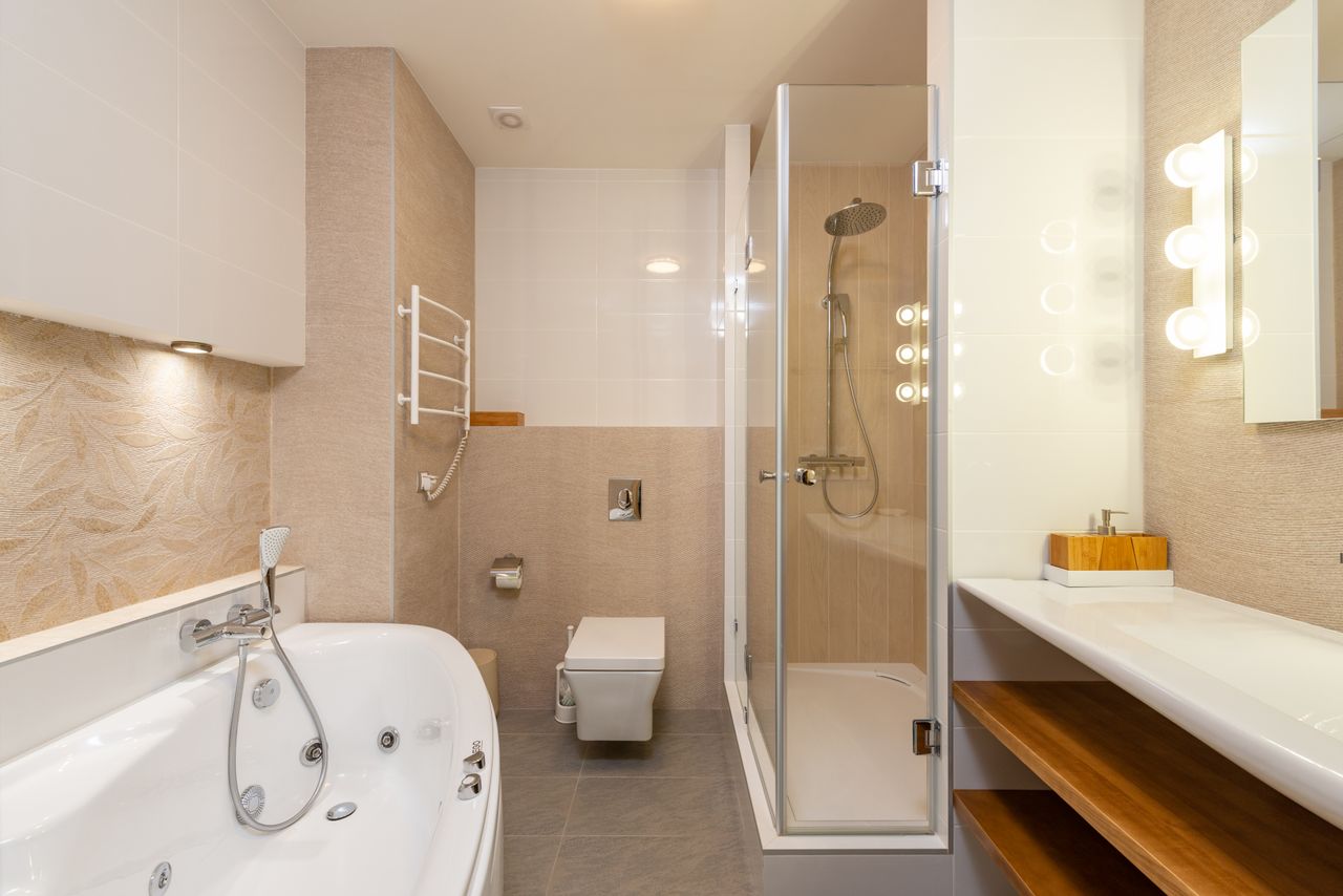 Contemporary bathroom featuring bathtub, shower, and elegant interior design elements.